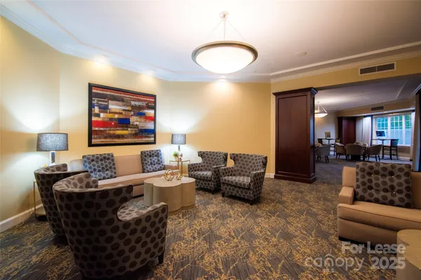 a room with lots of furniture and a chandelier