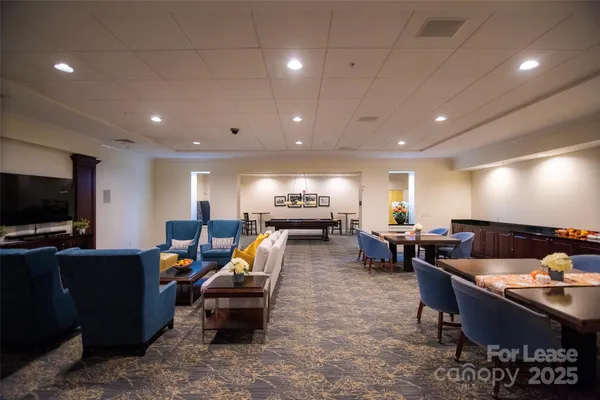 a living room with furniture a large window with wooden floor