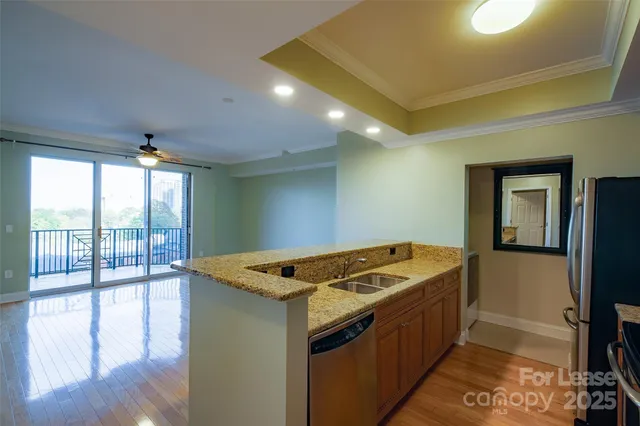 a view of a room with wooden floor and window