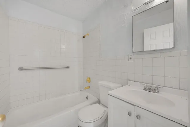 a bathroom with a sink toilet and vanity