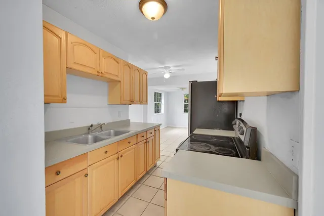 a kitchen with stainless steel appliances granite countertop a sink a stove and a refrigerator