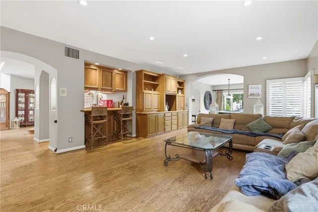 a living room with furniture and a gym machine