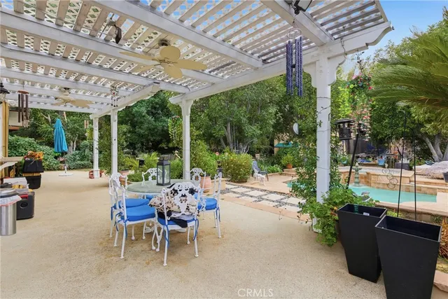 a view of a swimming pool with sitting area and garden