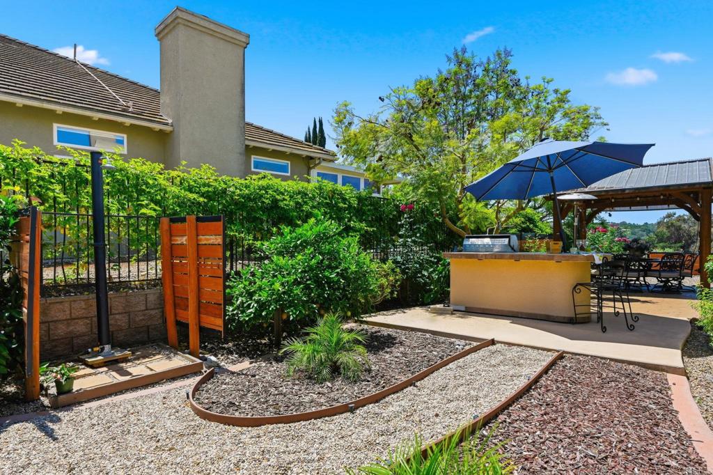 3835 Las Flores Drive Fallbrook, CA 92028 - Photo 51 of 73 a view of a chairs and table under an umbrella in backyard