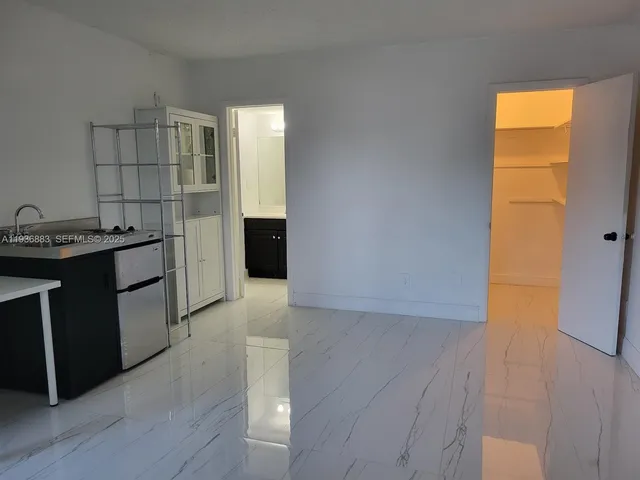 a kitchen with a sink and a refrigerator