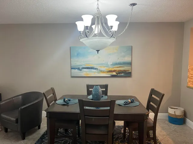 a view of a dining room with furniture wooden floor and chandelier