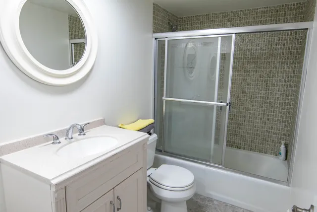 a bathroom with a sink toilet and shower