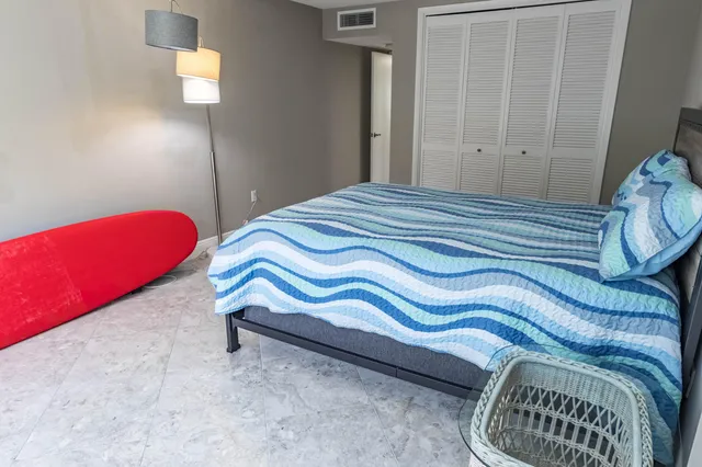 a bedroom with a bed and a chair