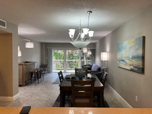 a view of a dining room with furniture wooden floor and chandelier