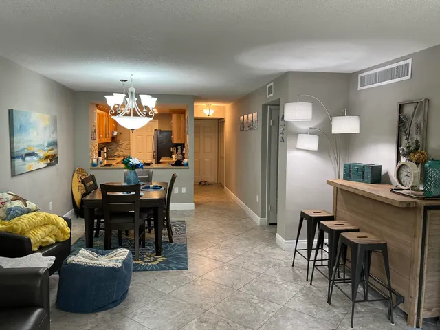 a view of a dining room with furniture and a chandelier