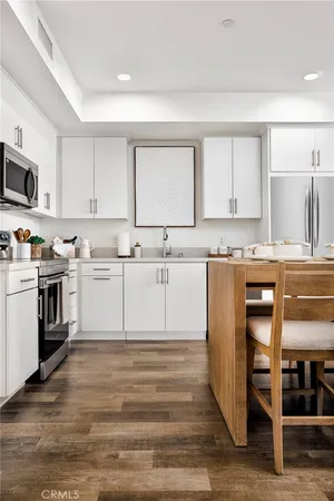 a kitchen with a white cabinets and white appliances