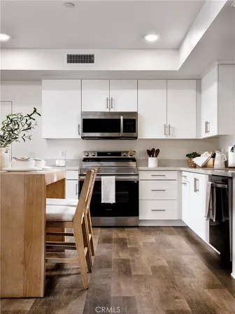 a kitchen with a stove a sink and a refrigerator