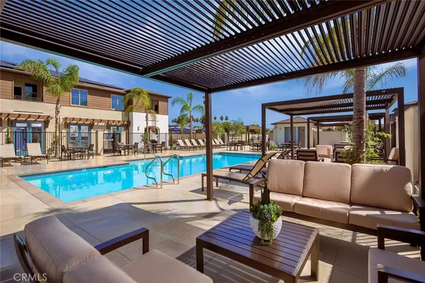 a view of a patio with couches table and chairs with wooden floor