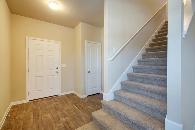 a view of bedroom and hall with wooden floor
