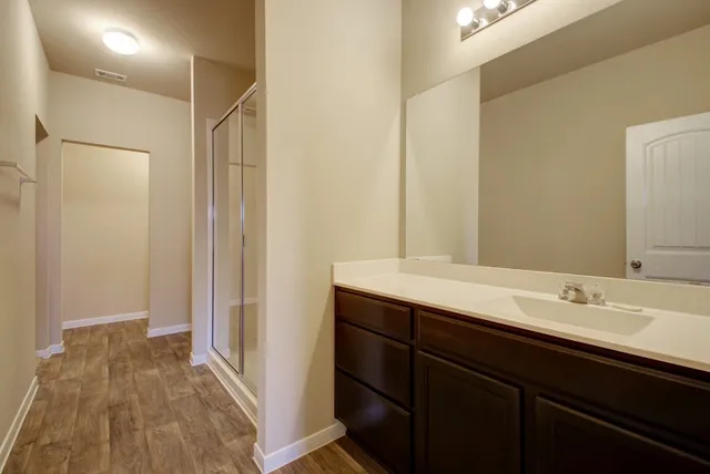 a bathroom with a sink toilet and shower