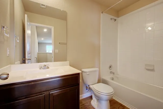 a bathroom with a sink toilet and a mirror