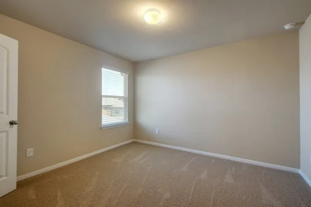 a backyard of a house with wooden fence