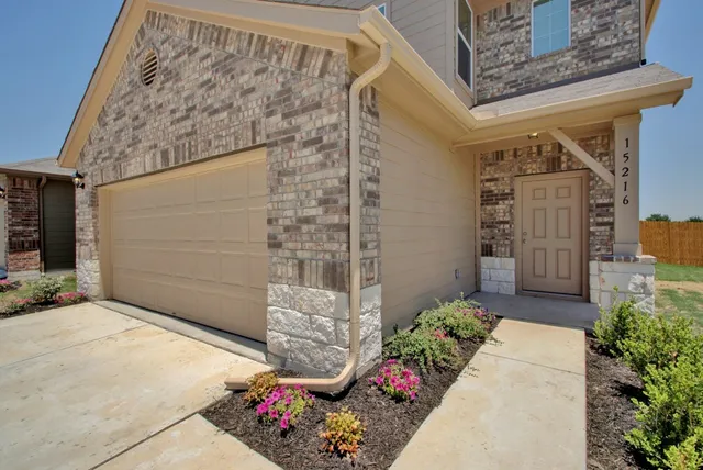 a couple of flower plants in front of door