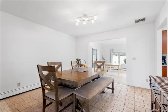 a view of a dining room with furniture and a chandelier fan