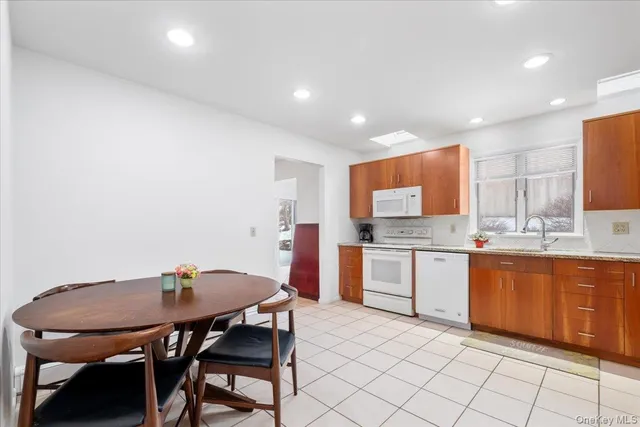 a kitchen with stainless steel appliances kitchen island granite countertop a sink and cabinets