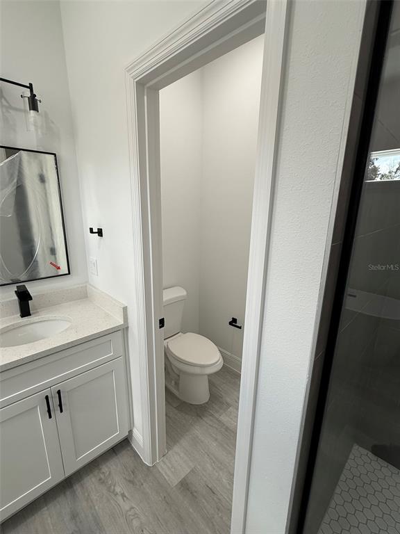 4875 Southwest 159th Lane Ocala, FL 34473 - Photo 11 of 32 a bathroom with a granite countertop sink toilet and shower