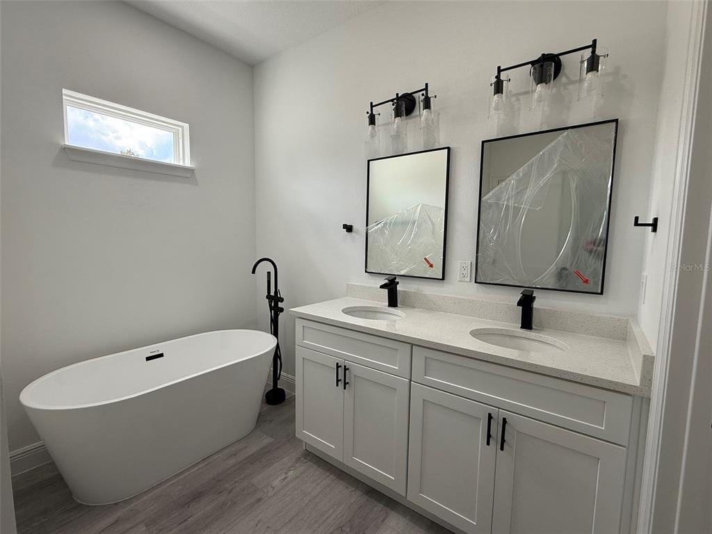 4875 Southwest 159th Lane Ocala, FL 34473 - Photo 12 of 32 a bathroom with a double vanity sink mirror and bathtub