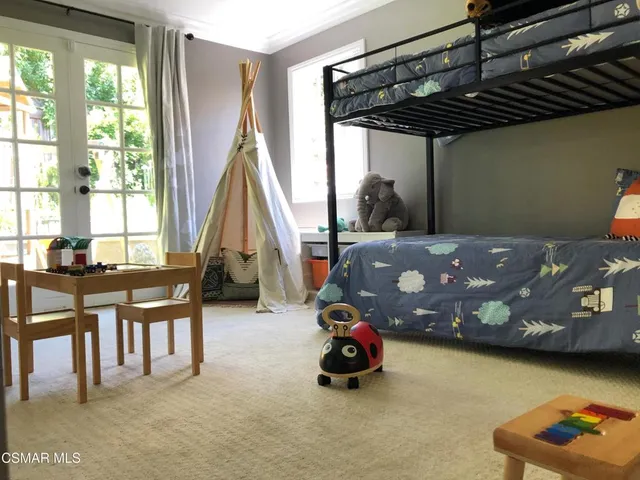 a bedroom with furniture and a window