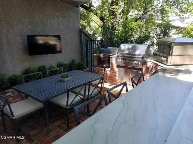 a outdoor dining space with furniture and potted plants