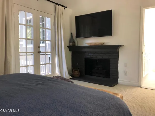 a living room with a fireplace and a flat screen tv