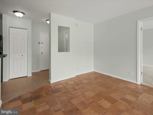 a view of an empty room and closet area