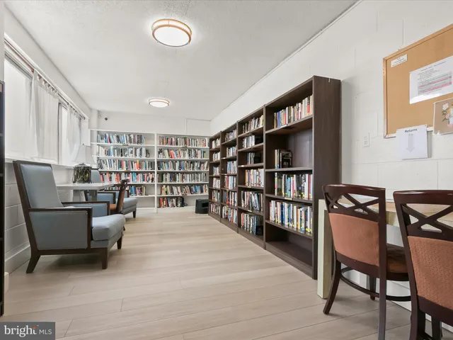 a front view of multi story building with retail shops