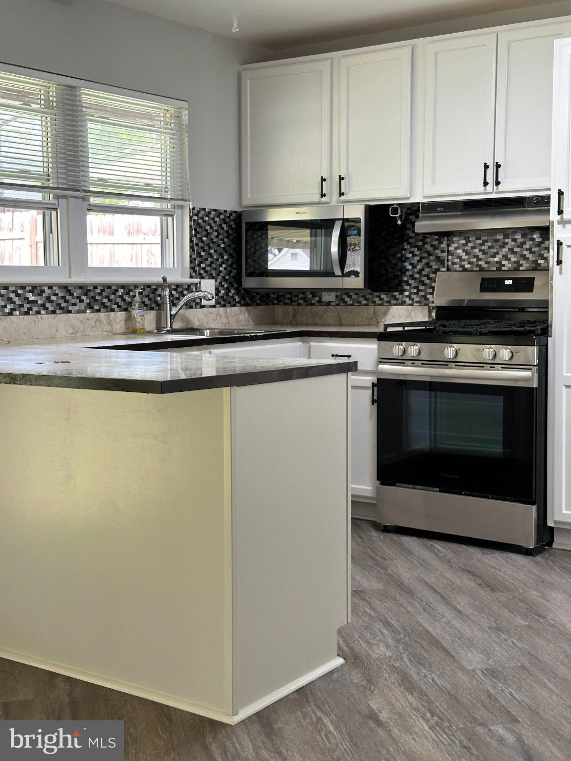 8336 Scotts Level Road Baltimore, MD 21208 - Photo 15 of 55 Modern kitchen with sleek finishes.