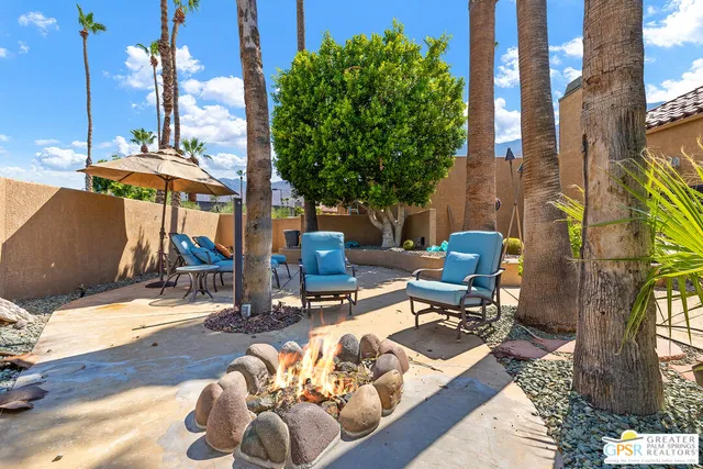 a view of a patio with a table and chairs