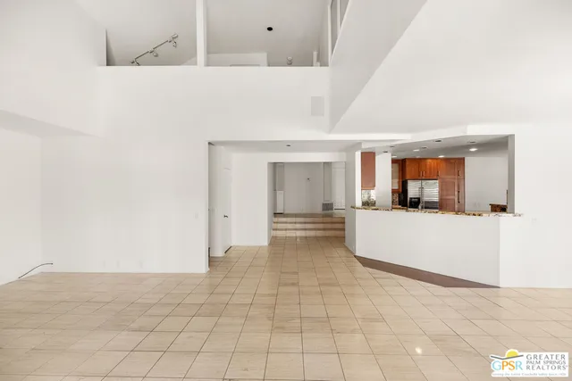 a view of empty room with wooden floor and fireplace