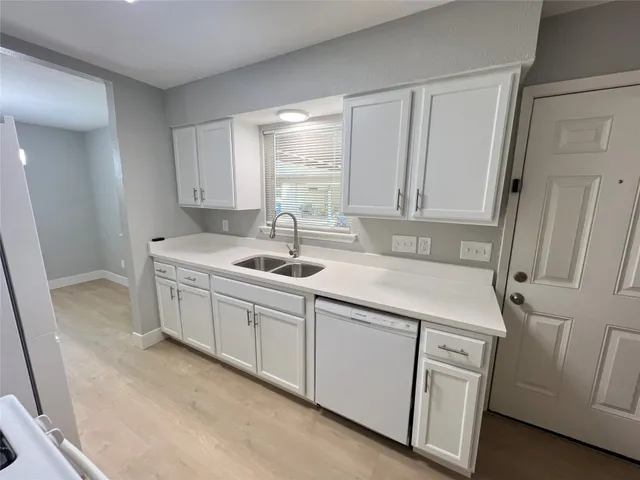 a kitchen with a sink cabinets and window