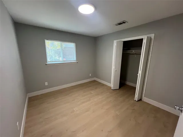an empty room with closet and window