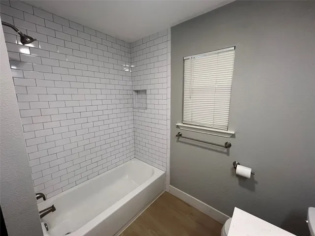 a bathroom with a bathtub and shower