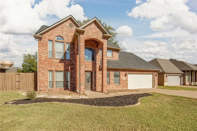 front view of a house with a dry trees