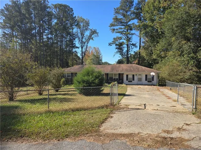 a view of a house with yard and sitting area