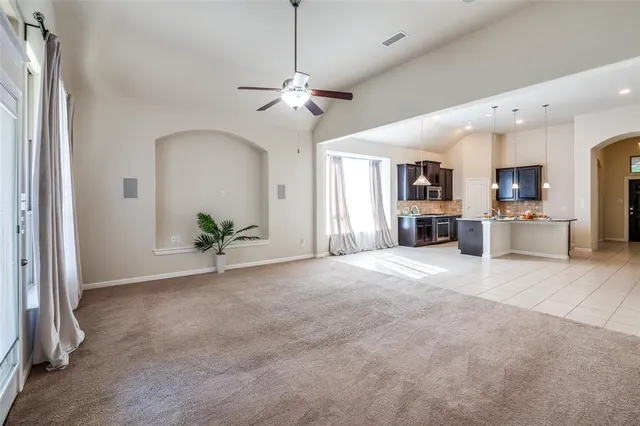 a view of an empty room with a fireplace and a window