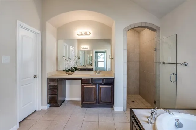 a spacious bathroom with a granite countertop sink and a mirror