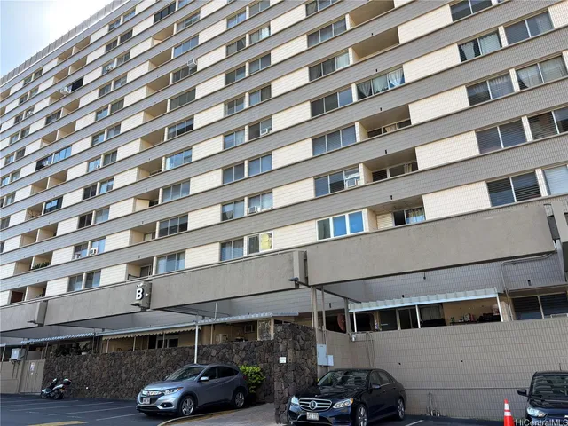 a front view of a building with parking space