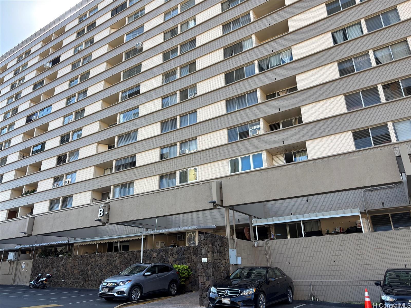 a front view of a building with parking space