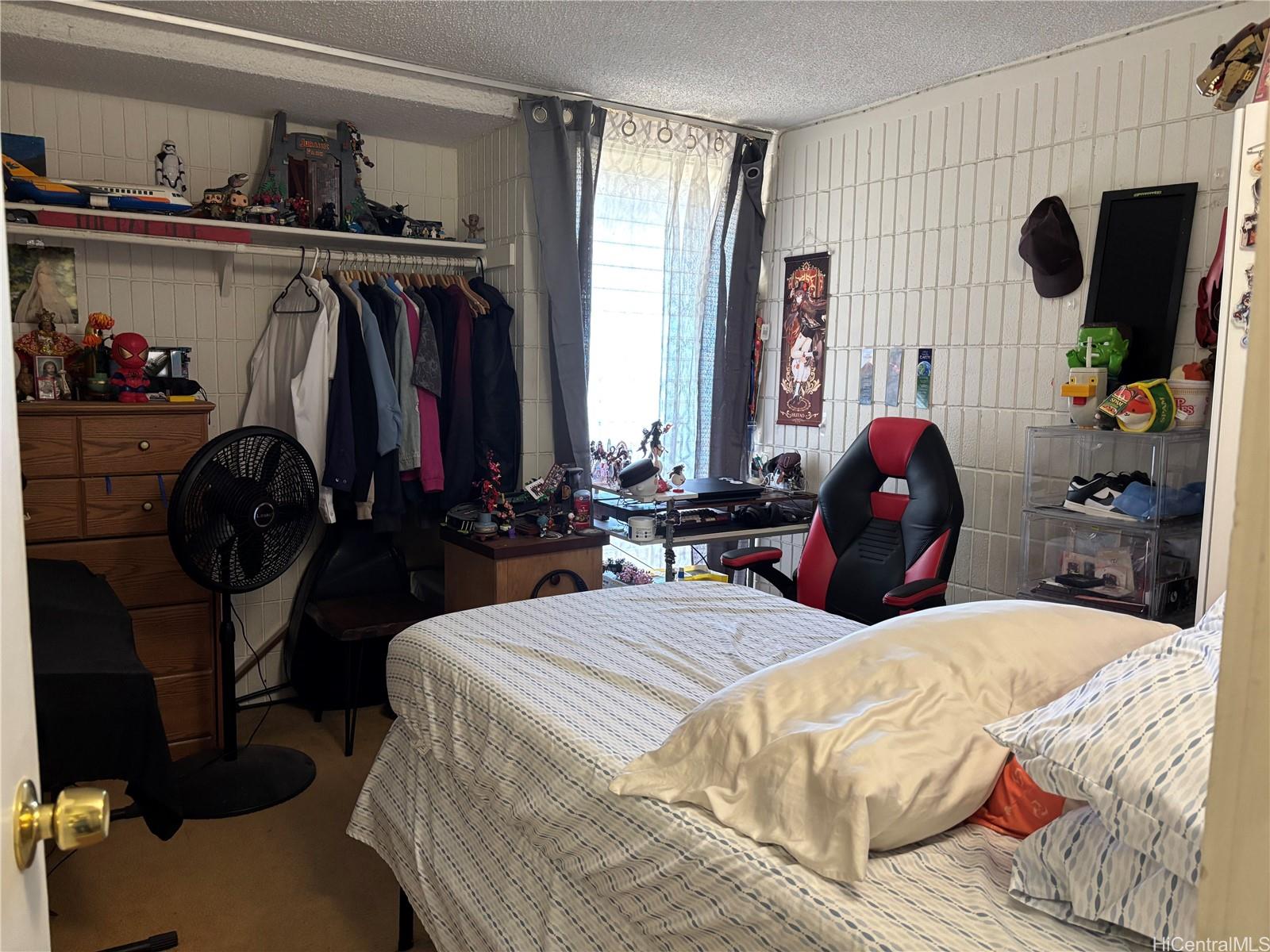 3215 Ala Ilima Street, Unit B404 Honolulu, HI 96818 - Photo 6 of 11 a bed room with two bed and a large mirror