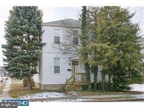 41 Chestnut Street Woodbury, NJ 08096 - Photo 1 of 1 a brick building with trees in front of it