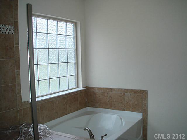 1500 Ridgehaven Road, Unit 147 Waxhaw, NC 28173 - Photo 7 of 14 a bathroom with a bathtub and window