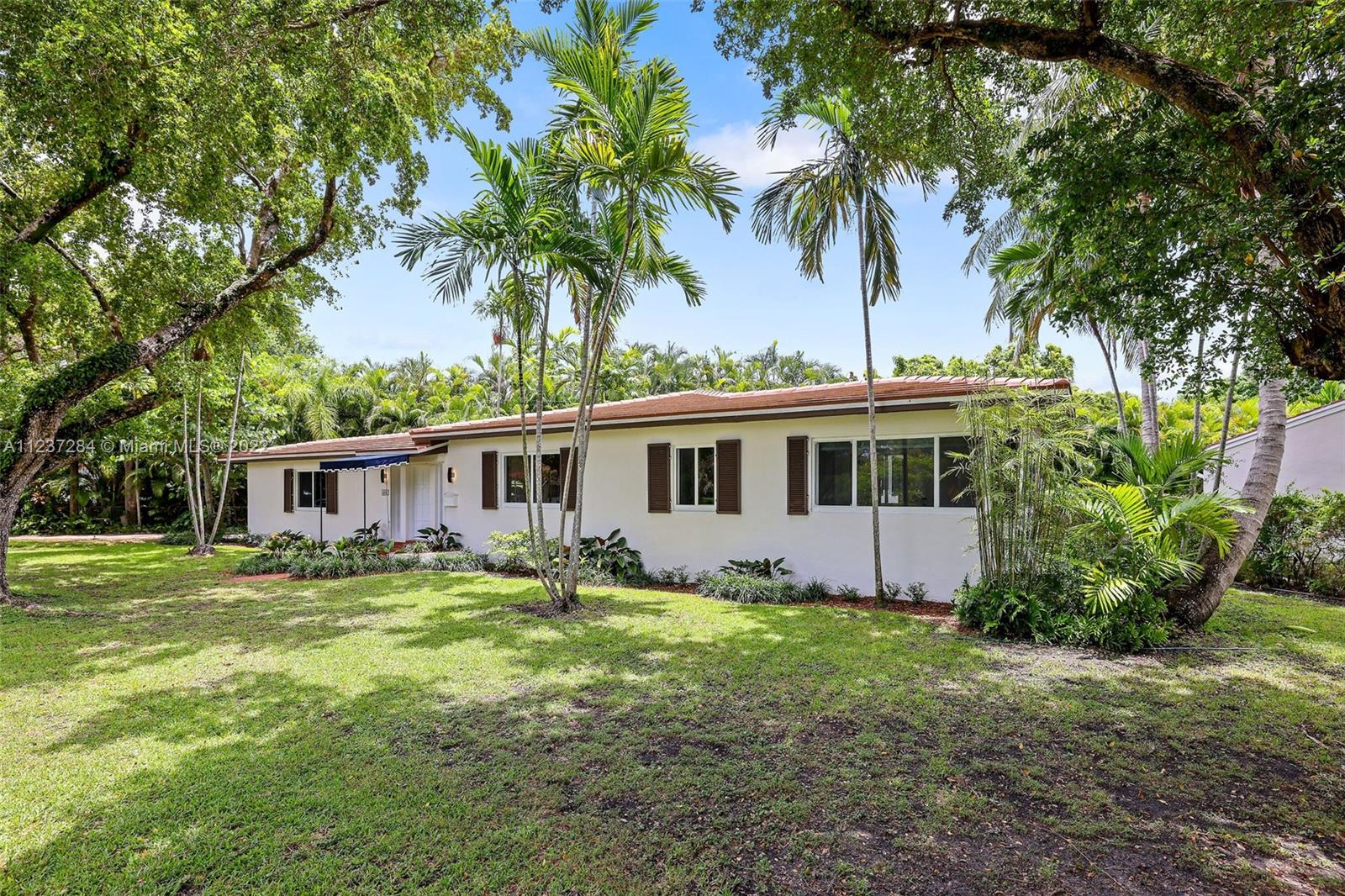 a front view of a house with a garden