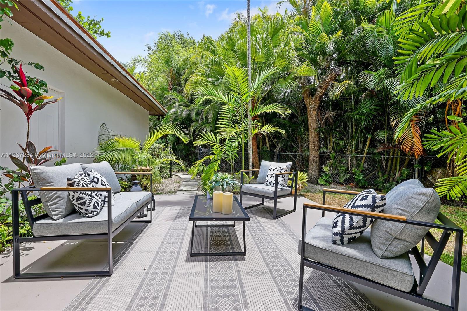 440 Blue Road Coral Gables, FL 33146 - Photo 16 of 20 a view of a backyard with sitting area