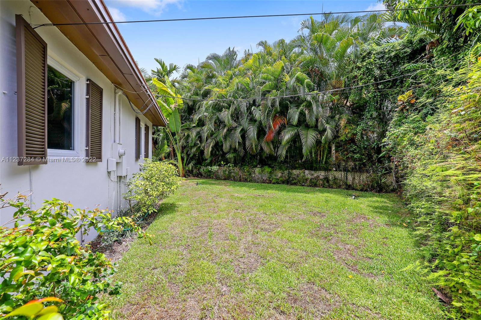 440 Blue Road Coral Gables, FL 33146 - Photo 18 of 20 front view of a house with a yard