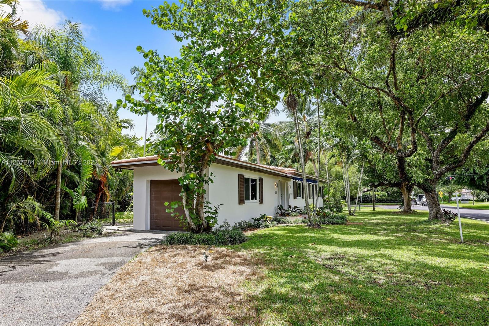 440 Blue Road Coral Gables, FL 33146 - Photo 2 of 20 front view of a house with a yard